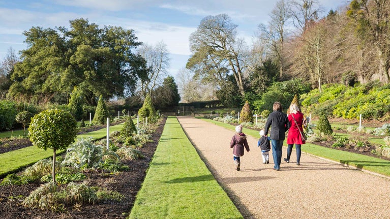 A family exploring the garden in winter at Dyrham Park, Gloucestershire